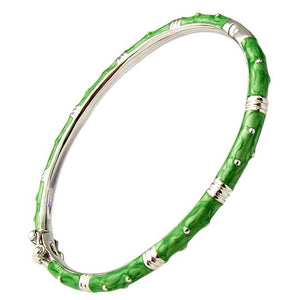 The zirconmania Bracelet Thin Gold tone Enamel Bangle 501B5339 features a bamboo-inspired design with bright green enamel sections, gold tone and silver accents for a stylish natural, textured look.