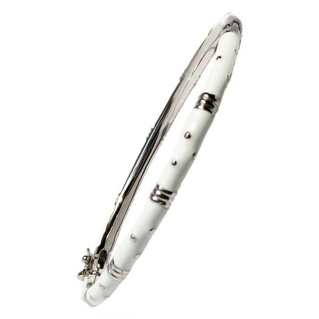 The zirconmania Bracelet Thin Gold tone Enamel Bangle 501B5339 is a slim, round white enamel bracelet with small silver dots and gold-tone accent bands, displayed at an angle on a plain white background.