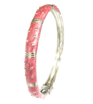 The zirconmania Bracelet Hinged Enamel Bangle 501B41902 features pink marbled enamel sections, raised silver studs, and horizontal bands. This silver bangle has a hinged design and discreet safety catch for easy, secure wear.