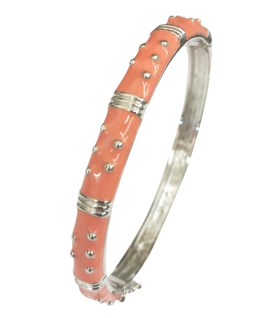 The zirconmania Bracelet Hinged Enamel Bangle 501B41902 is a silver bangle with a pink enamel section, raised silver dots, evenly spaced silver bands, and a secure hinged design.