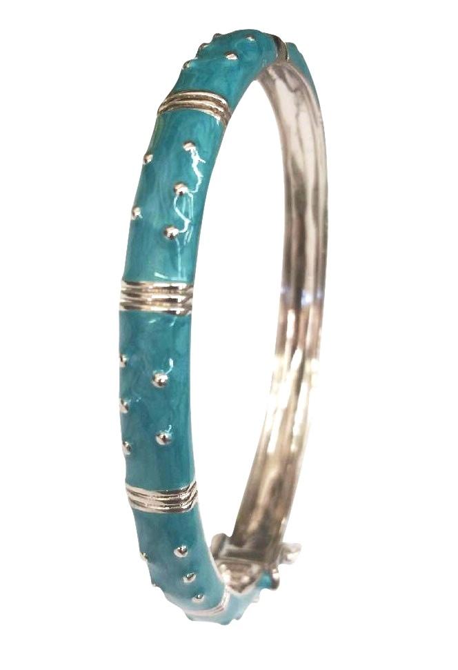 The zirconmania Bracelet Hinged Enamel Bangle 501B41902 features a silver finish, turquoise enamel coating, silver dot accents, horizontal bands, and a secure safety catch for added peace of mind.