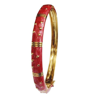 The zirconmania Bracelet Hinged Enamel Bangle 501B41902 features a gold finish with shiny red enamel, accented by gold studs and raised segments. This hinged bracelet includes a secure safety catch for easy and stylish wear.