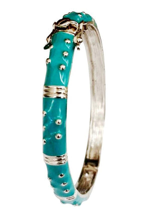 The zirconmania Bracelet Hinged Enamel Bangle 501B41902 features turquoise enamel, raised silver dot accents, decorative silver bands, a secure safety catch, and a convenient hinged clasp.