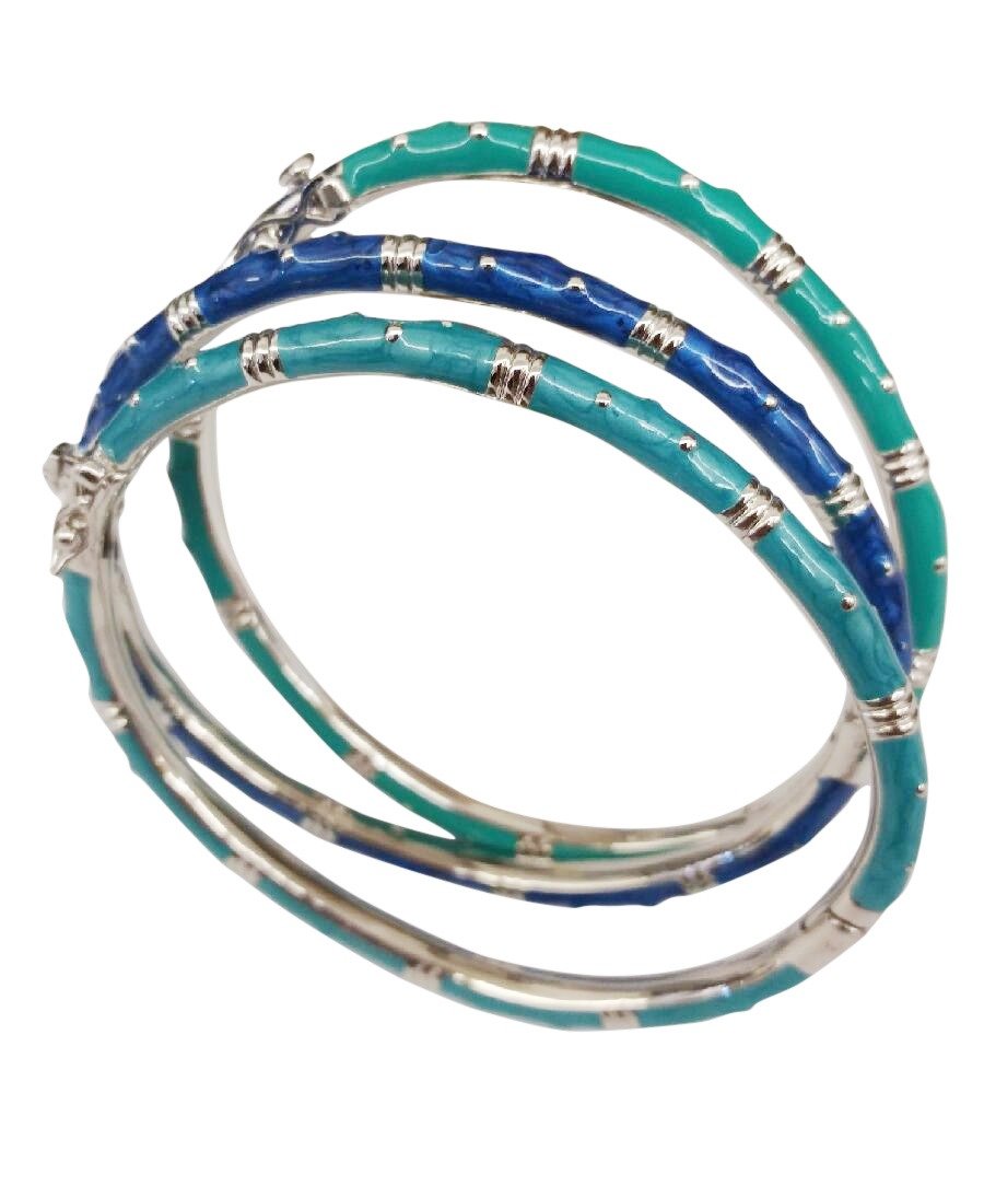 The zirconmania Bracelet Thin Gold tone Enamel Bangle 501B5339 features stacked, slightly overlapping gold-tone bangles with alternating teal blue, dark blue, and green enamel for a striking bamboo-inspired look.