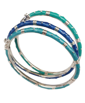 The zirconmania Bracelet Thin Gold tone Enamel Bangle 501B5339 features stacked, slightly overlapping gold-tone bangles with alternating teal blue, dark blue, and green enamel for a striking bamboo-inspired look.