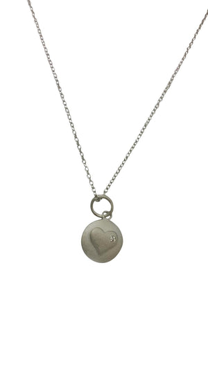 Round matte finish pendant featuring a Zirconite Cubic Zirconia in heart