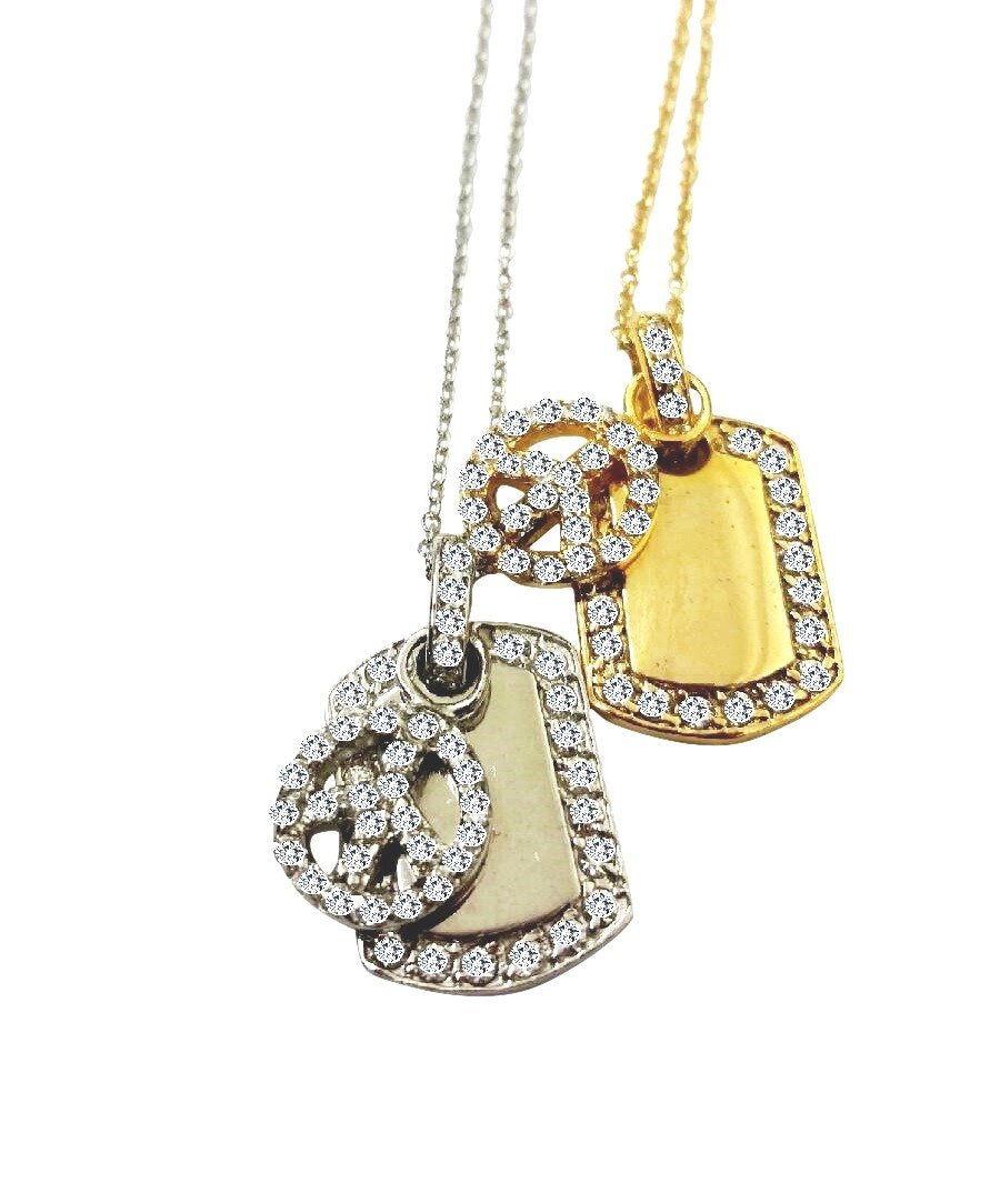 dog tag with bordered CZ pave featuring an electroplated pave peace sign charm S/S .582P2631