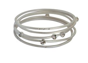 The zirconmania Bracelets Gold Stack-able .622B0102 features multiple overlapping gold bands accented with clear, round gemstones for a modern, minimalist style. Displayed on a white background.