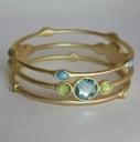 The zirconmania Bracelet 3 Gold Satin With Round Multi Crystals Bangles Set 622B0293 features three gold satin bands adorned with blue and green crystals, adding elegance to any look.