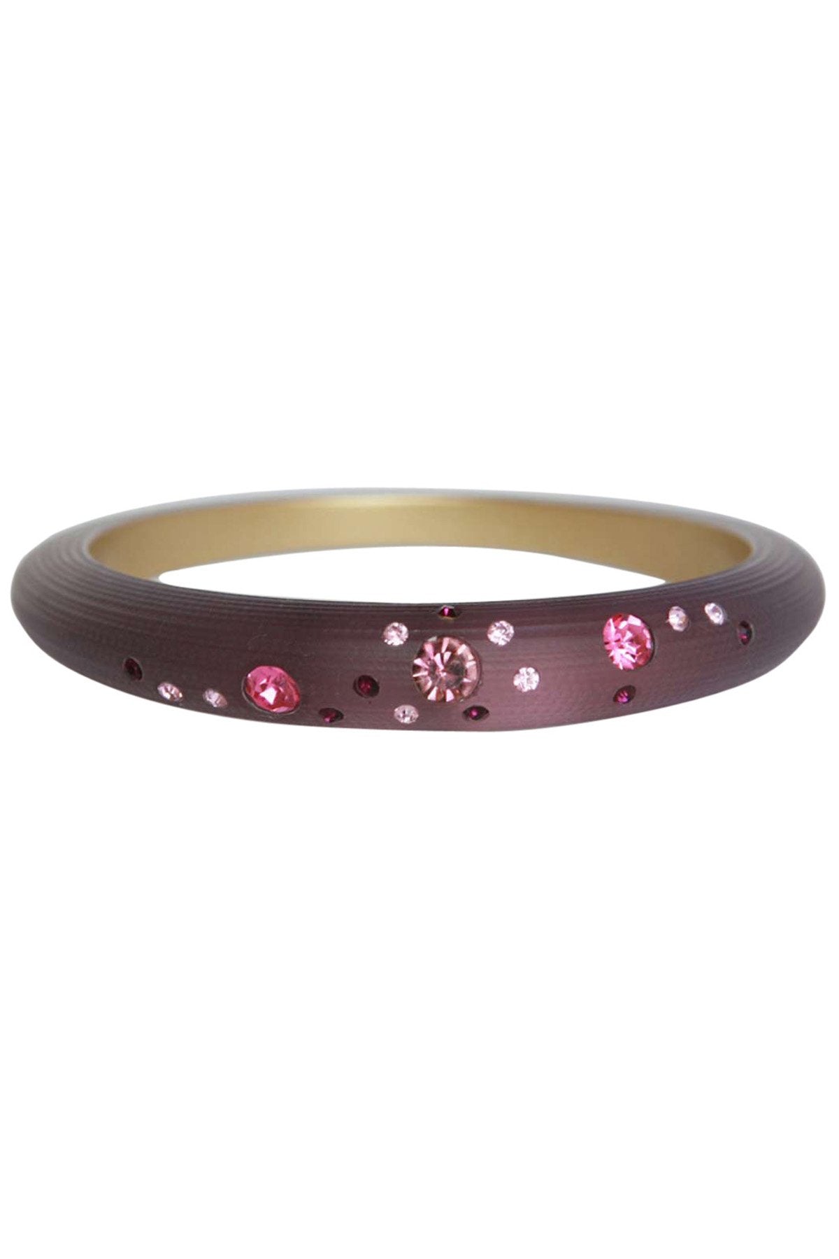 The zirconmania Bracelet Jeweled frosted slender bangle 629B364 is a slim, dark brown bracelet with a gold inner lining, adorned with scattered pink and clear gemstones in various sizes on the outer surface.