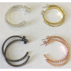 Four pairs of zirconmania 30mm Electroplated Feather Weight Hoop Earrings (637E14302) in silver, gold, black, and rose gold are arranged in a square on a white surface, each featuring a row of small square-cut stones along the hoop.