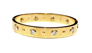 The zirconmania Bracelet Stainless Steel Wide Hinged High Polished Bangle (655B1045) features a sleek surface with evenly spaced round bezel-set diamonds and small screw motifs between each stone.
