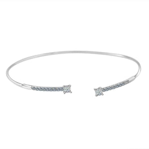 The zirconmania BraceletFine Open End Bangle Cubic Zirconia 702B1207 is a delicate silver bracelet with open ends, each embellished with a square cubic zirconia and rows of sparkling stones.