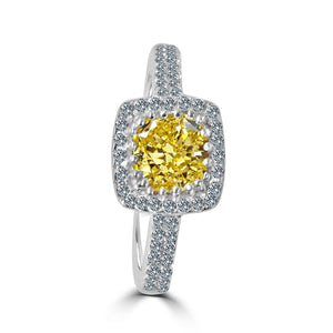 The zirconmania Ring 1CT Cushion Radiant Center w/Halo Pave CZ Sterling Silver (705R0251) features a cushion-cut yellow gemstone with a halo and band of sparkling pave CZ diamonds, displayed on a white background.