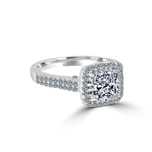 The zirconmania Ring 1CT Cushion Radiant Center w/Halo features a rectangular cushion-cut CZ in a halo setting with pave CZ accents on the sterling silver band for extra sparkle.