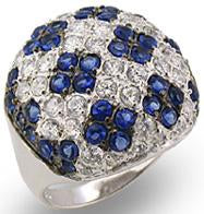 A sterling silver ring with a wide pave cubic zirconia top, featuring blue and clear zirconia stones. Ring