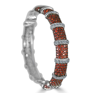 The zirconmania Bracelet Face-off line Stations wide hinged bangle (698B100) features fine cubic zirconia clusters and segmented silver rings with clear stones, creating a textured, elegant look.