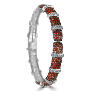 The zirconmania Bracelet Face-off line Stations wide fine Cubic Zirconia Set Hinged Bangle 698B100 features silver segments with red gemstones and bands of sparkling cubic zirconia for a bold, elegant look.