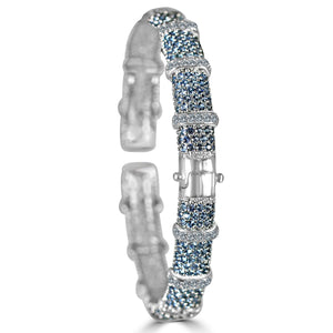 The zirconmania Bracelet Face-off line Stations wide fine Cubic Zirconia Set Hinged Bangle 698B100 features segmented sections with clusters of blue and white sparkling stones and a secure hinged clasp.