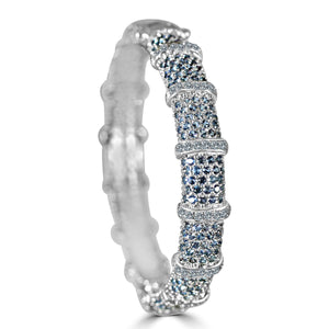 The zirconmania Bracelet Face-off Line Stations wide fine Cubic Zirconia Set Hinged Bangle 698B100 features clusters of blue and clear cubic zirconia separated by vertical silver bars, displayed upright on a white background.