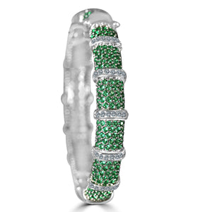 The zirconmania Bracelet Face-off Line Stations Wide Fine Cubic Zirconia Set Hinged Bangle (698B100) features clusters of green gemstones and rows of clear stones, creating a segmented, dazzling design.