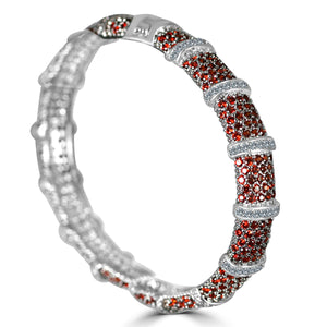 The zirconmania Bracelet Face-off Line Stations Hinged Bangle 698B100 features fine cubic zirconia in alternating red and white segments, creating a sparkling pattern with a smooth, polished finish and classic elegance.