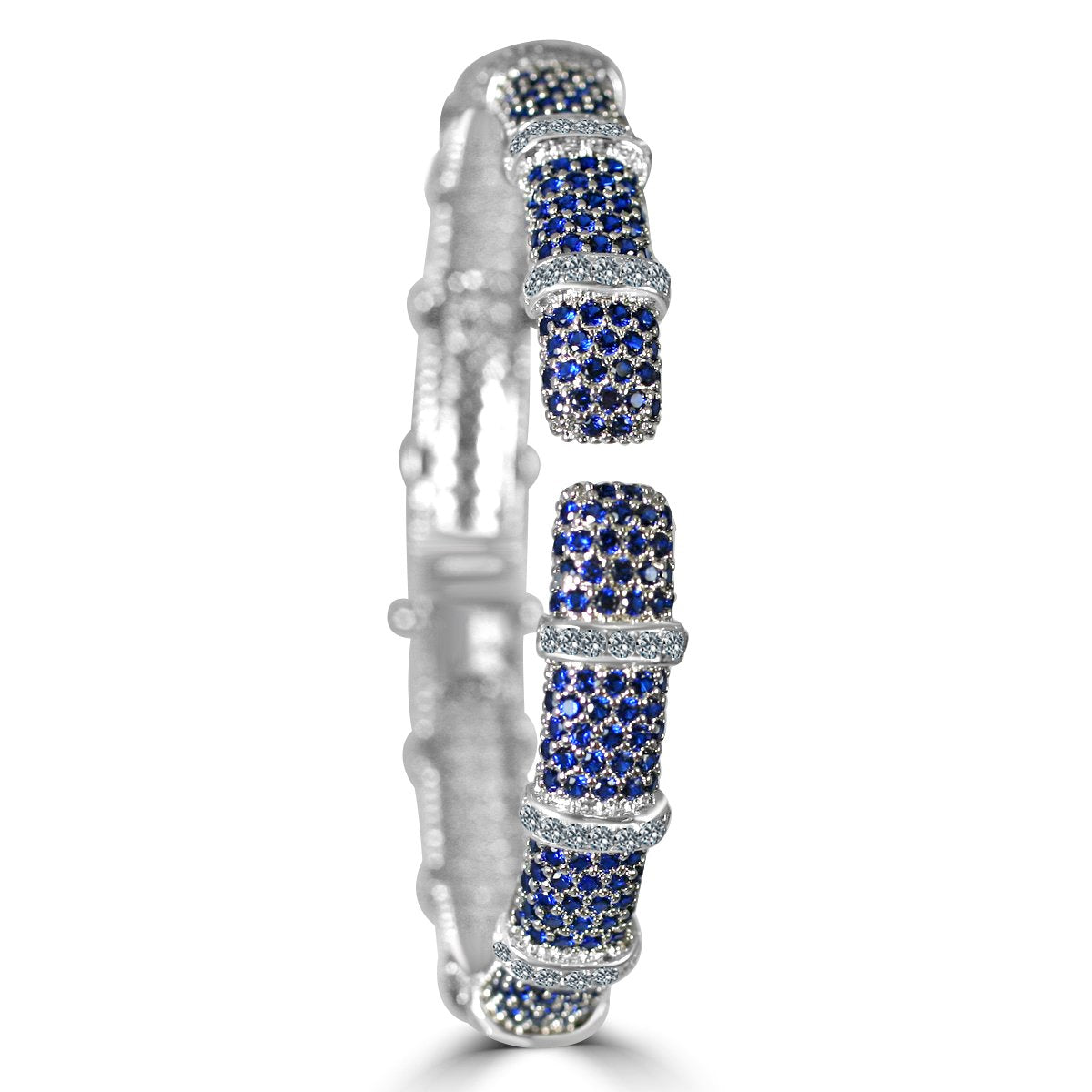 The zirconmania Bracelet Face-off line Stations wide fine Cubic Zirconia Set Hinged Bangle 698B100 features a silver finish with alternating blue and white cubic zirconia sections, textured bands, and intricate detailing for a sparkling segmented look.