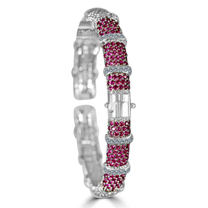 The zirconmania Bracelet Face-off line Stations wide fine Cubic Zirconia Set Hinged Bangle 698B100 features alternating bands of red stones and sparkling white cubic zirconia, displayed upright on a white background.