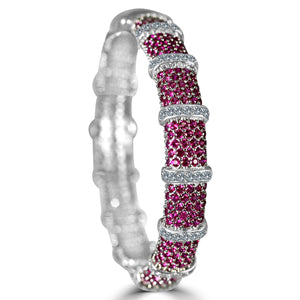 The zirconmania Bracelet Face-off line Stations wide fine Cubic Zirconia Set Hinged Bangle 698B100 features rows of sparkling cubic zirconia separated by sleek bands, forming a stylish segmented pattern around the wrist.