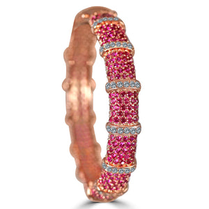 The zirconmania Bracelet Face-off line Stations wide fine Cubic Zirconia Set Hinged Bangle 698B100 features rose gold plating, rows of pink stones separated by sparkling white cubic zirconia, and a textured inner surface.