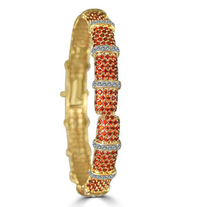 The zirconmania Bracelet Face-off line Stations wide fine Cubic Zirconia Set Hinged Bangle 698B100 features segments of small red stones and sparkling white zirconite for an ornate, eye-catching look.