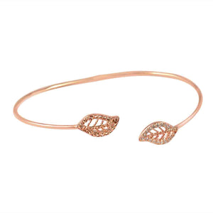 The zirconmania Fine Open End Pave Leaf Bangle Set (702B1202) features two leaf-shaped ends adorned with sparkling Zirconite cubic zirconia in a delicate rose gold design.