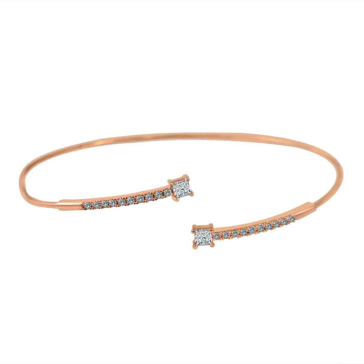 The zirconmania BraceletFine Open End Bangle Cubic Zirconia 702B1207 features a delicate rose gold design with two ends adorned by sparkling cubic zirconia stones that gradually increase in size toward the tips.
