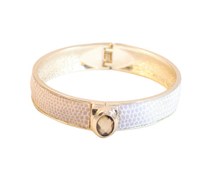 Shimmering centered oval jeweled designer style bracelet bangle finished with a snakeskin-like texture accent in gold-tone 629B-82033