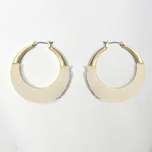 The zirconmania Textured Satin Bezel Alloy Hoop Earring 661E581 features a gold-tone upper half and textured off-white lower half, with hinged saddle closure, showcased on a plain white background.