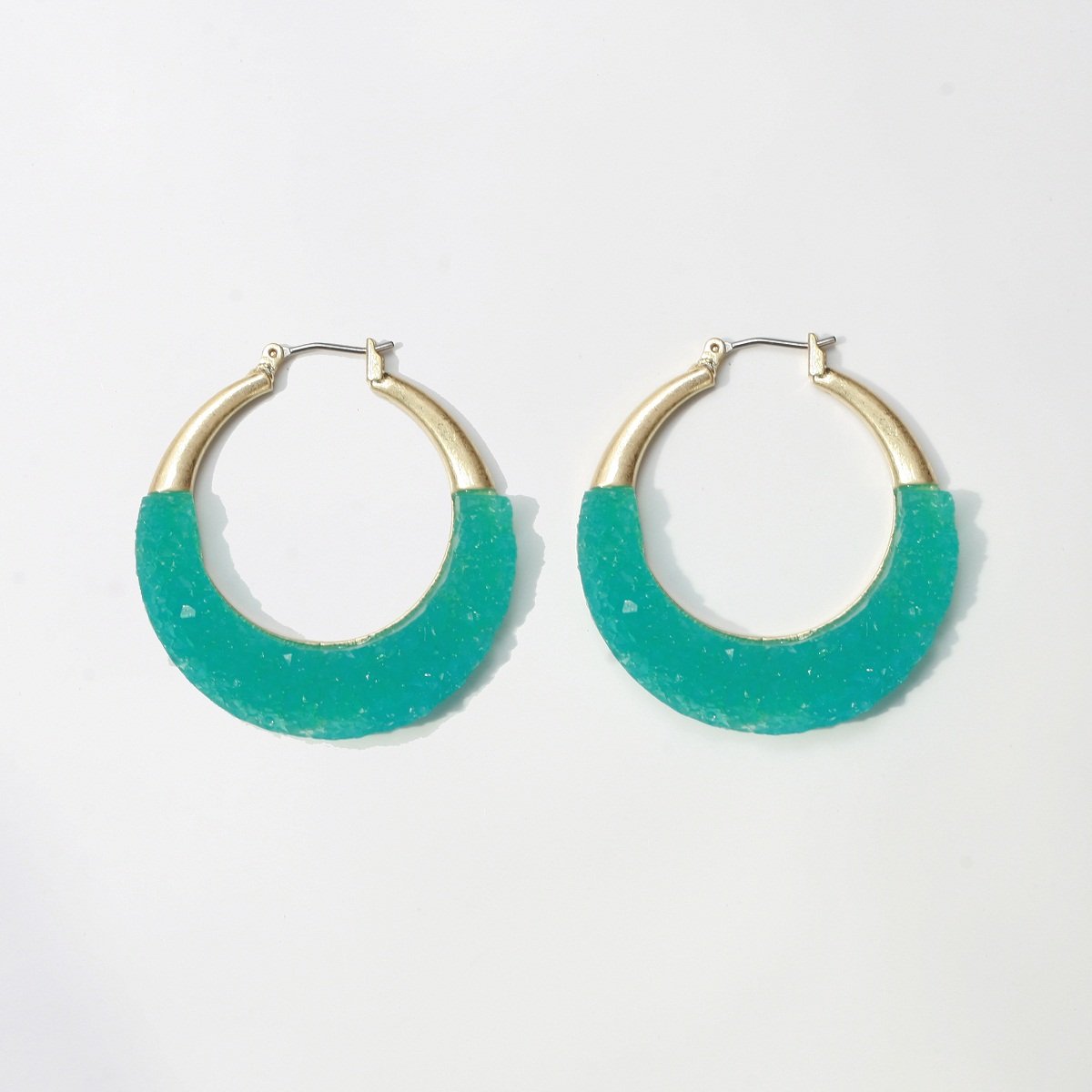 The zirconmania Textured Satin Bezel Alloy Setting Hoop Earring 661E581 features a hinged saddle closure, gold-tone metal at the top, and textured turquoise material on the lower half, shown against a white background.
