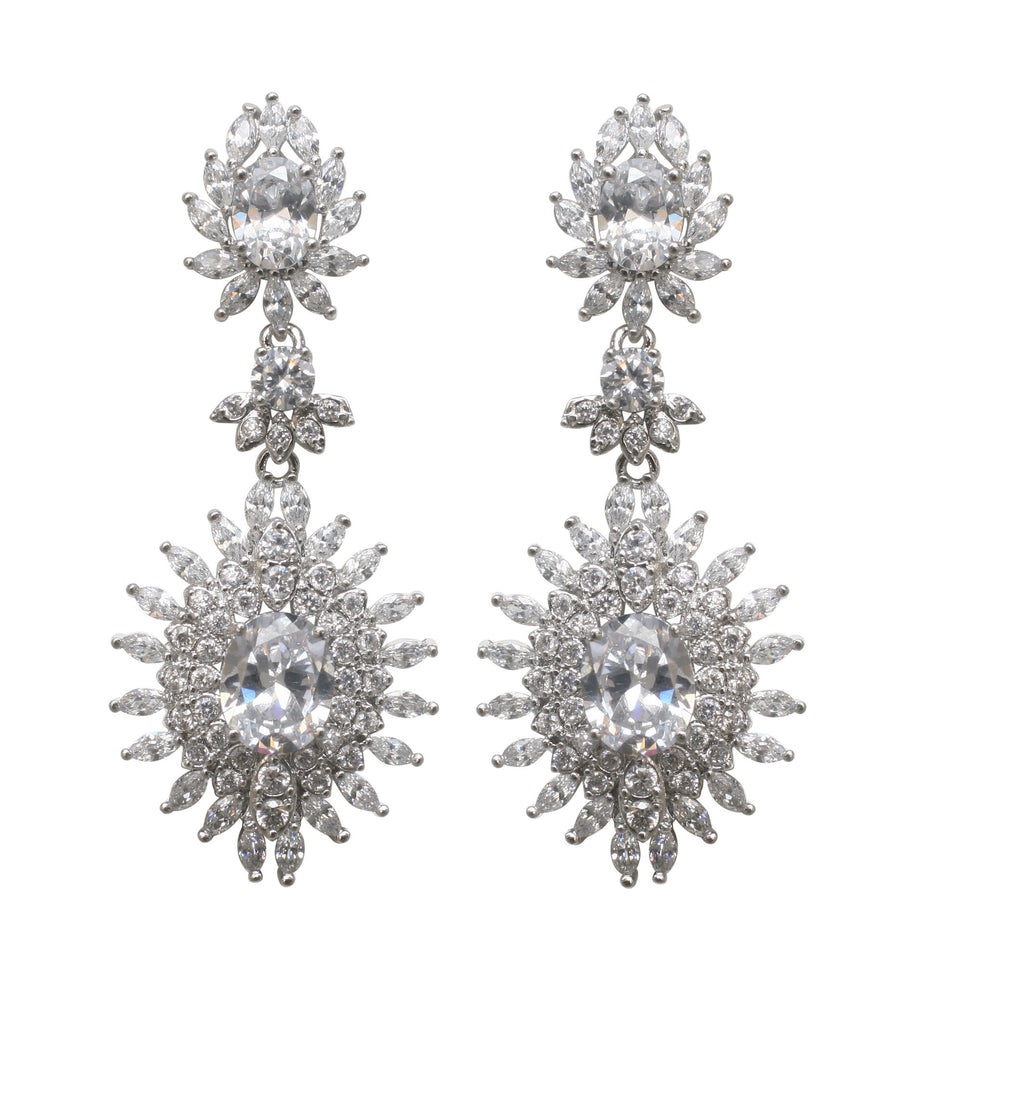 The zirconmania Earring Couture Oval Drop Post STE-9195 features ornate, rhodium-plated oval drop earrings with circular and marquise clear gemstones in a floral sunburst design for an elegant couture look.