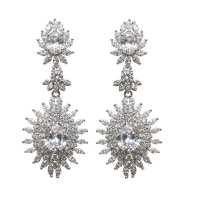 The zirconmania Earring Couture Oval Drop Post STE-9195 features ornate, rhodium-plated oval drop earrings with circular and marquise clear gemstones in a floral sunburst design for an elegant couture look.