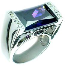 A sterling silver ring with a blue emery crystal (EM CZ) set in a silver band with a small round embellishment on the top. Ring 